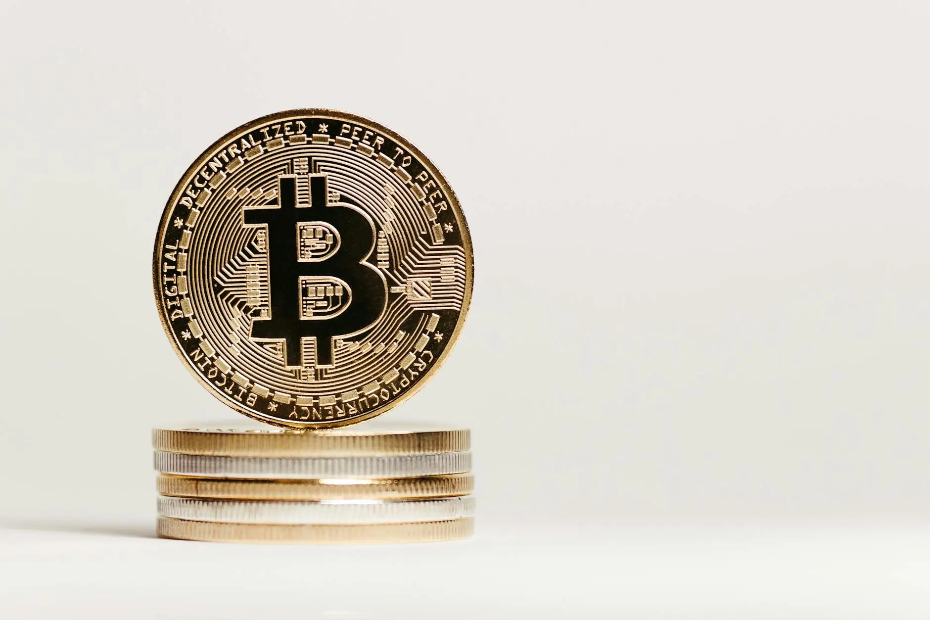 A stack of Bitcoin coins with the Bitcoin logo prominently displayed on top.