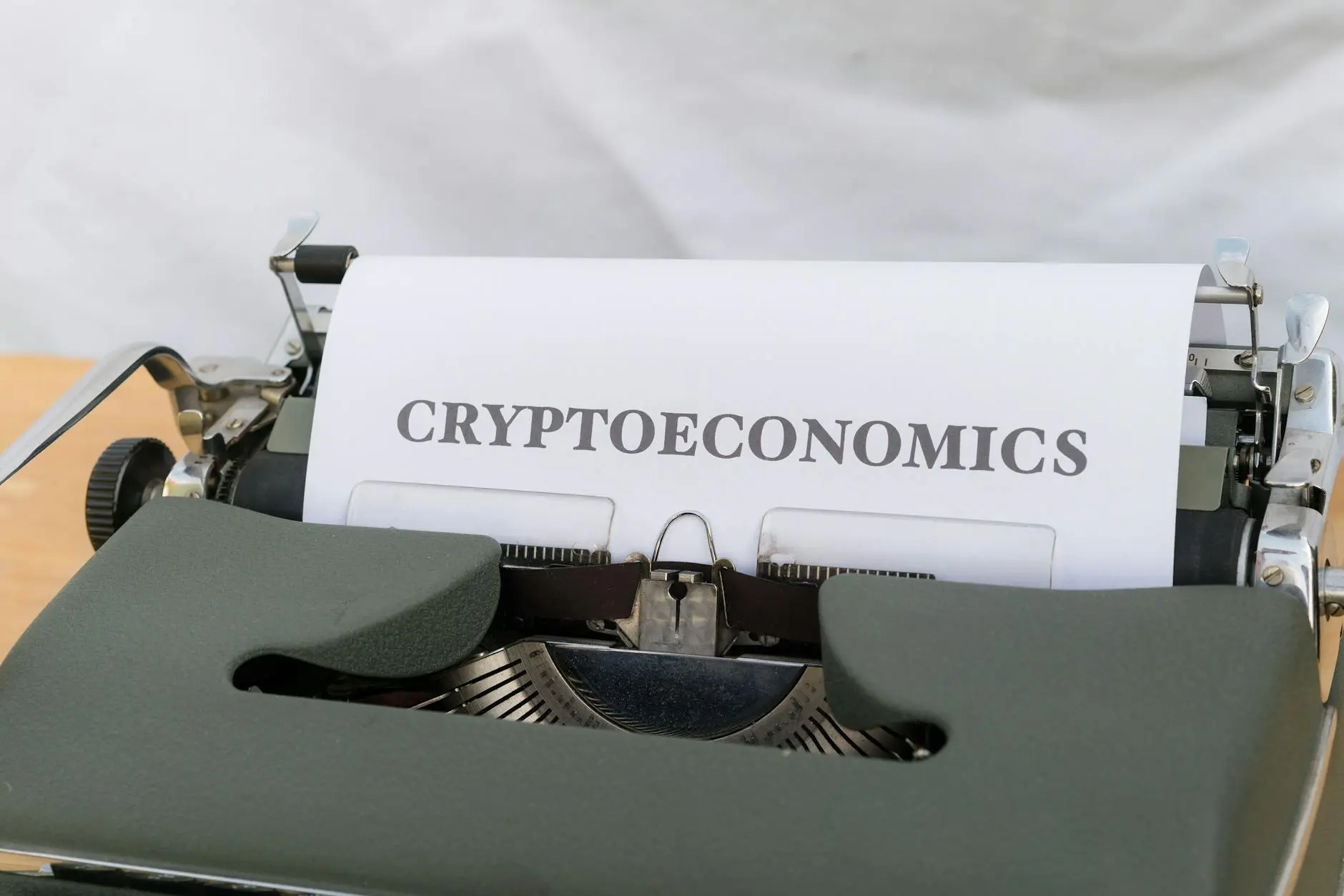 Close-up of a vintage typewriter with a sheet labeled 'CRYPTOECONOMICS'.