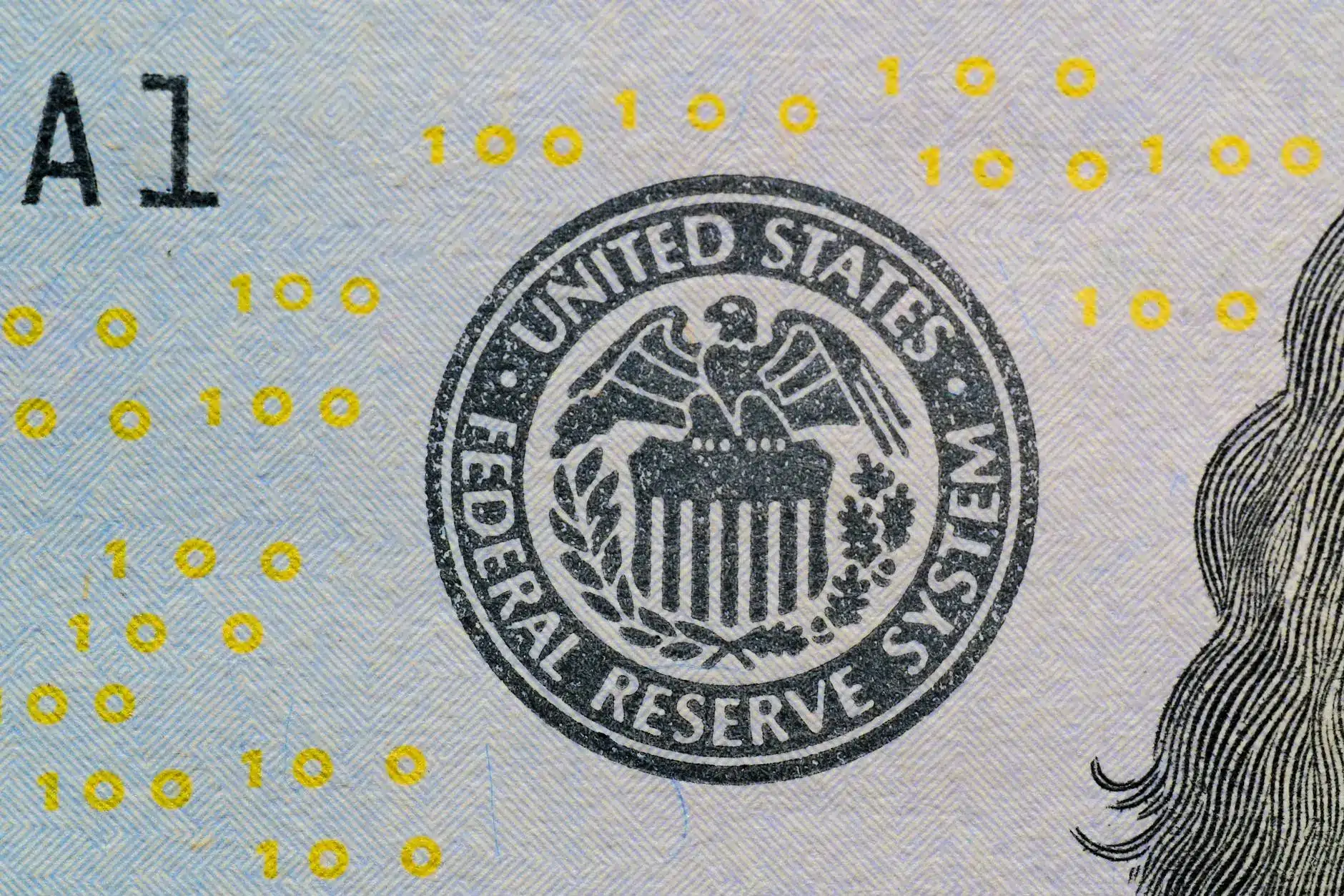 Close-up of the Federal Reserve System seal on a banknote.