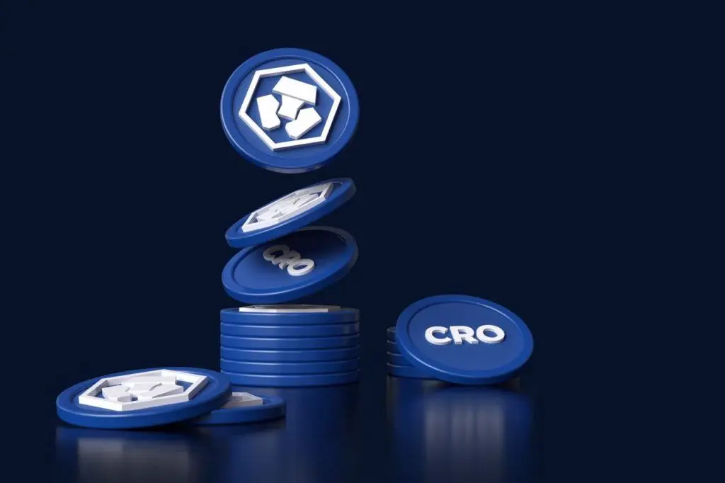 Stack of blue cryptocurrency coins with 'CRO' on one side against a dark background.
