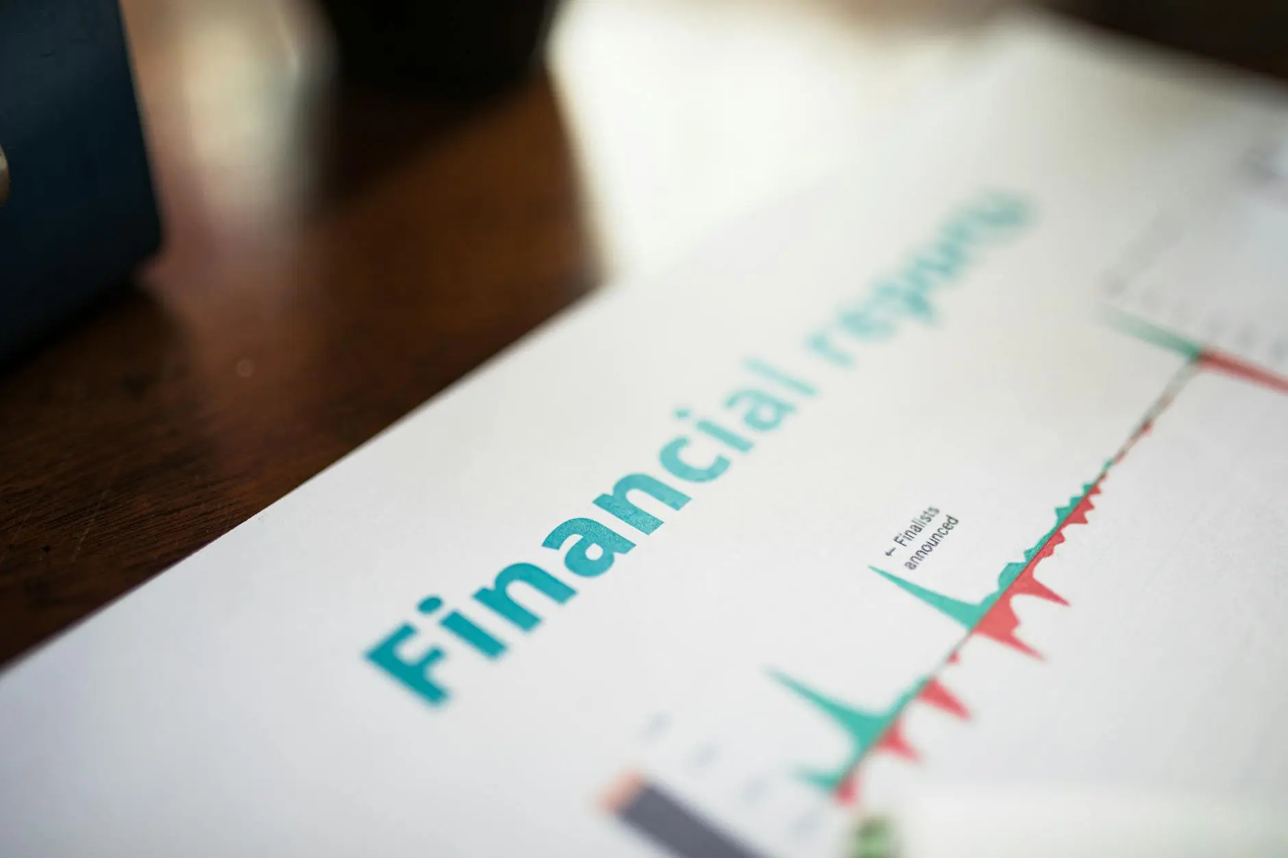 Close-up of a financial report document with graphs and the title 'Financial reports'.