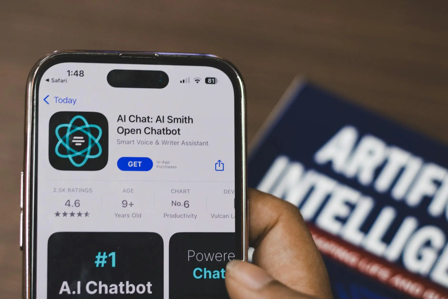 A hand holding a smartphone displaying an AI chatbot app download page.