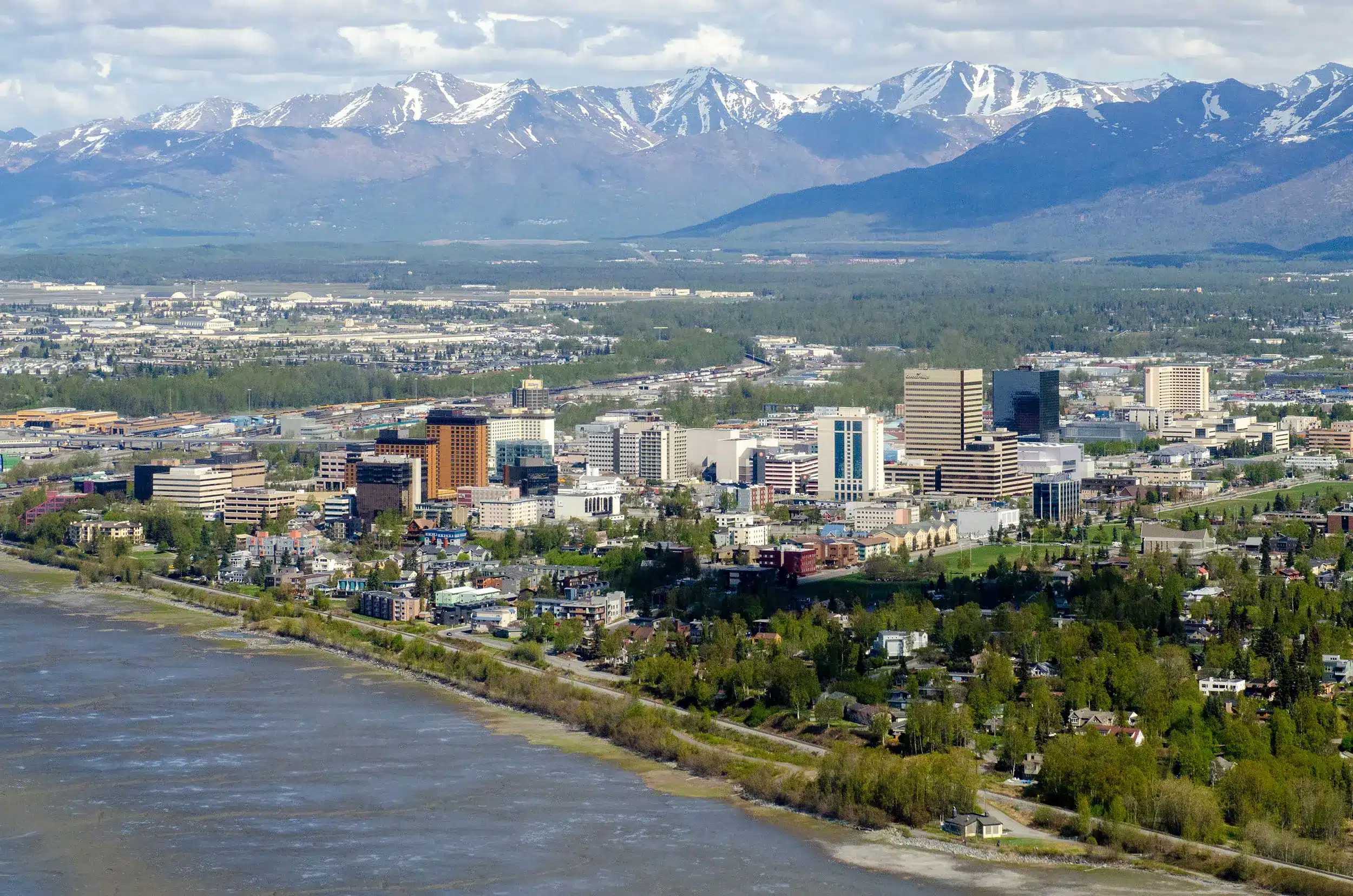 Aerial view of Anchorage, Alaska with mountains in the background.