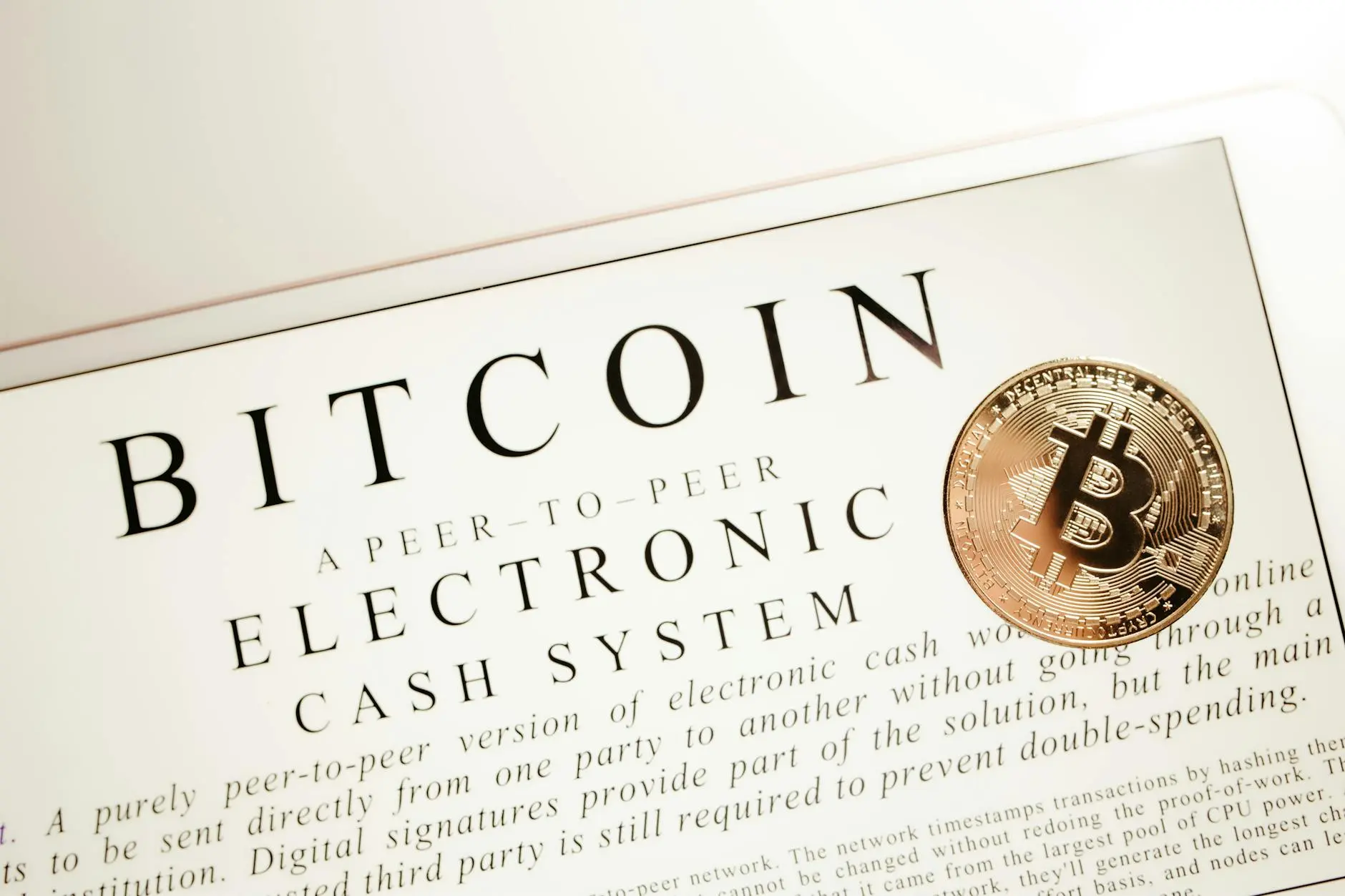 A Bitcoin coin on a white background with text about electronic cash systems.