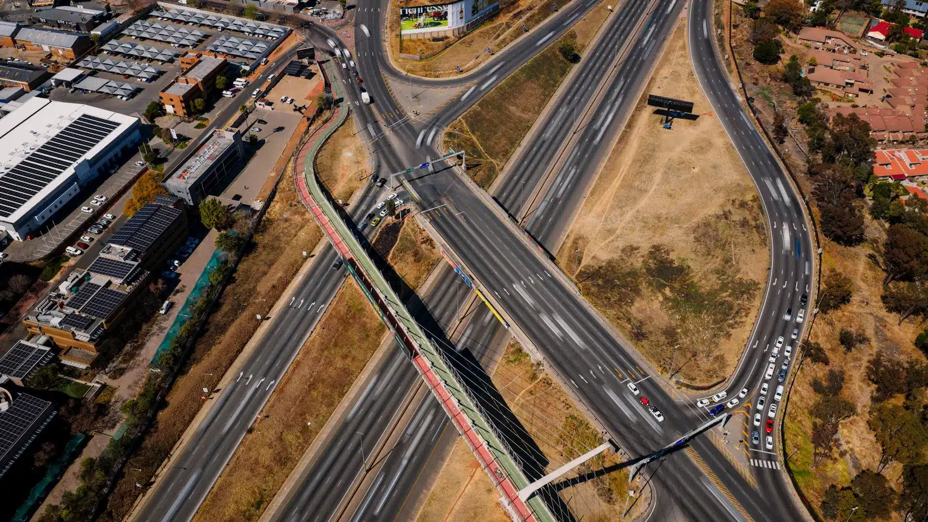 Aerial view of an intersection with multiple highways and surrounding urban infrastructure.