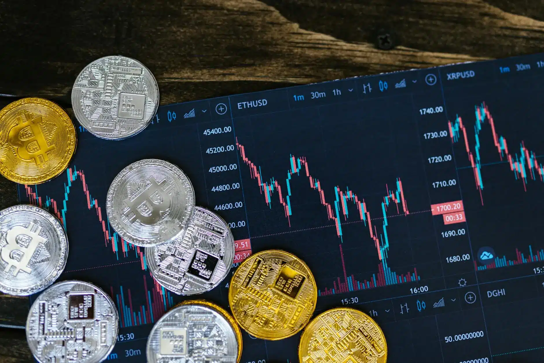 Cryptocurrency coins on a digital trading chart displaying market volatility.