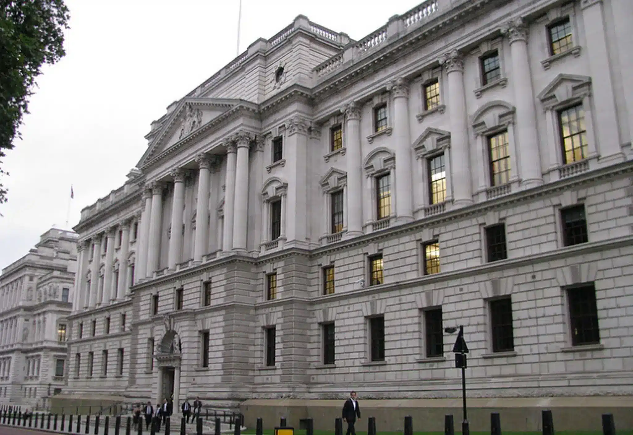 HM Treasury building in London with classic architecture and people walking by.