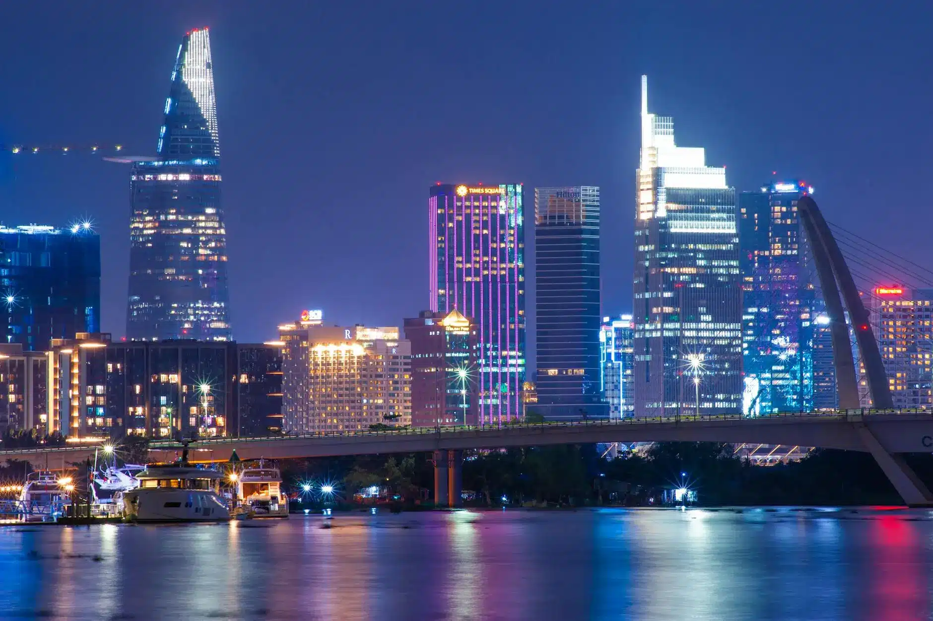 Night view of Ho Chi Minh City's skyline with modern skyscrapers and illuminated buildings.