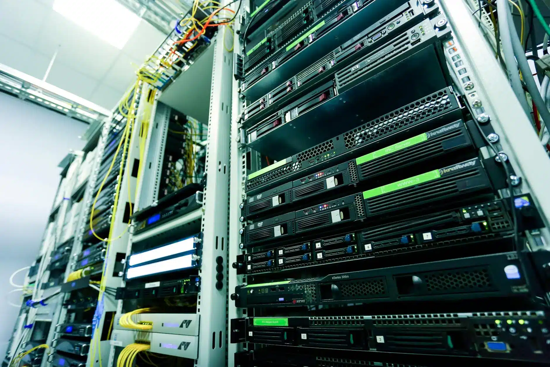 Rows of servers in a data center with colorful cables and indicators.