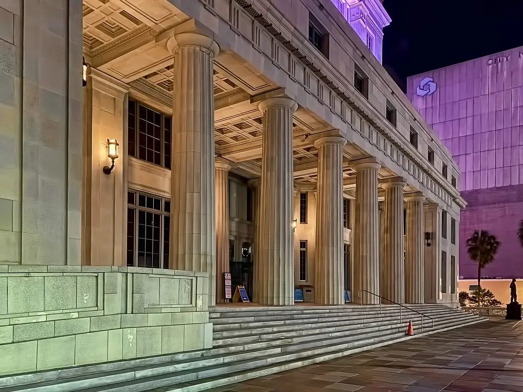 Miami Dade County Courthouse with lit columns and night ambiance.
