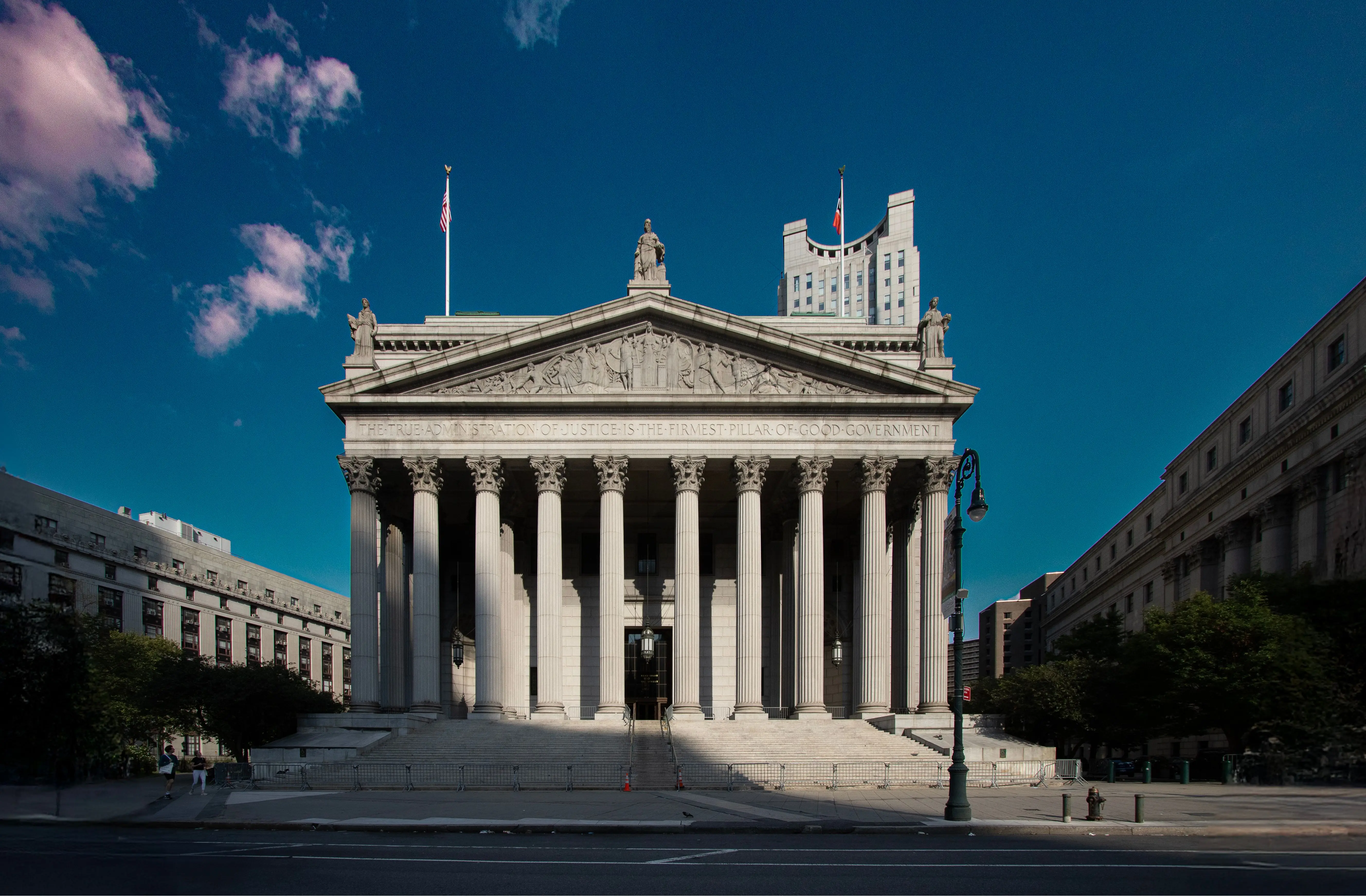 Exterior view of the New York State Supreme Court building with grand columns.