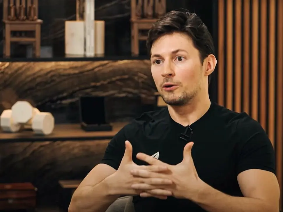 Pavel Durov speaking during an interview, gesturing with his hands.
