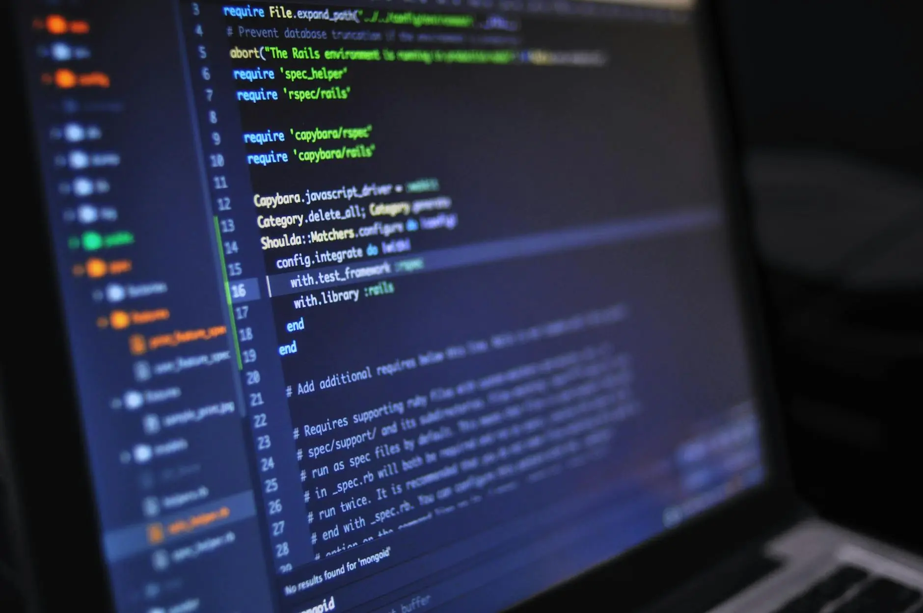 Close-up of coding environment displaying lines of code on a laptop screen.