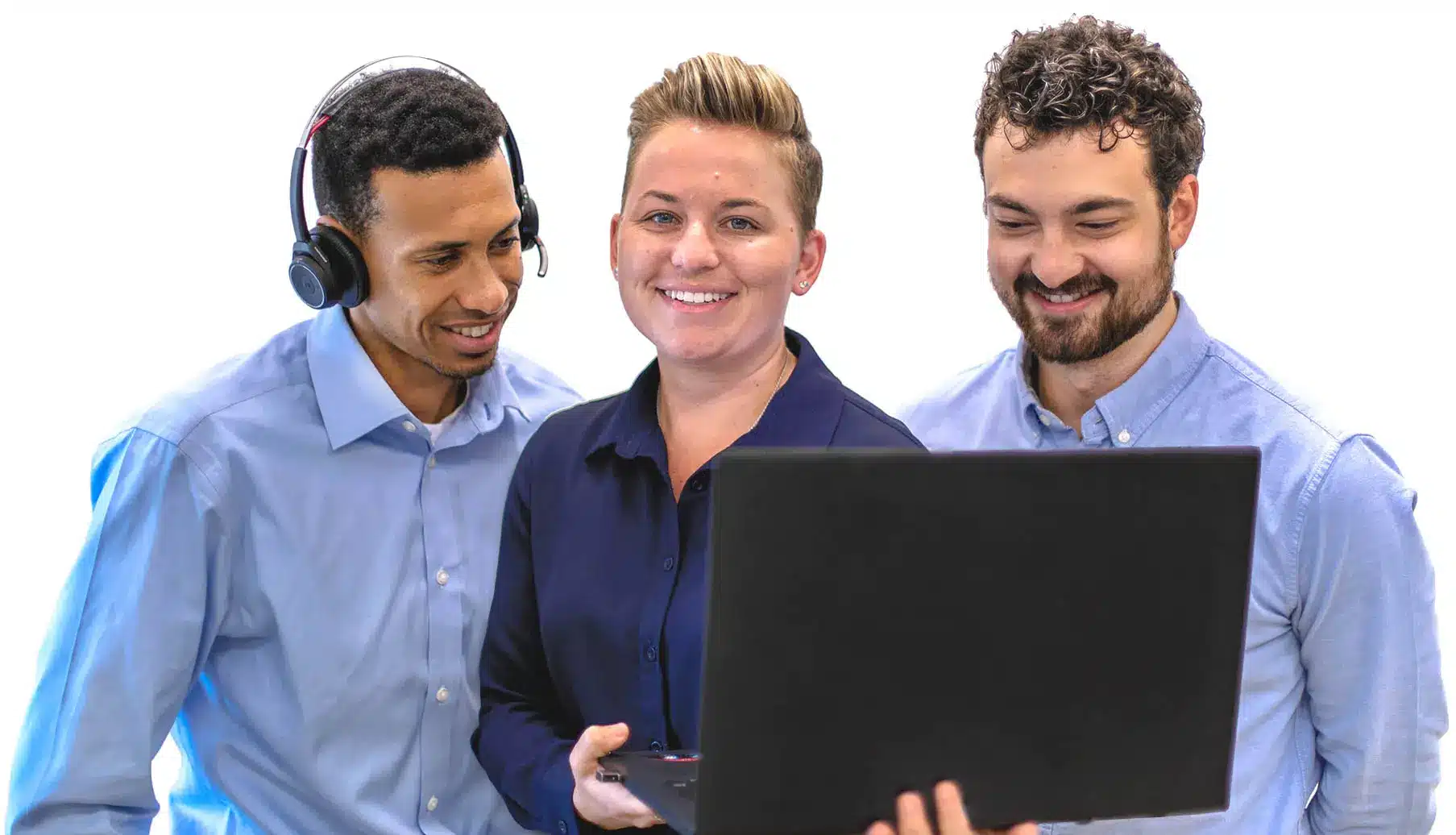 Three professionals engaged with a laptop, smiling and wearing business attire.