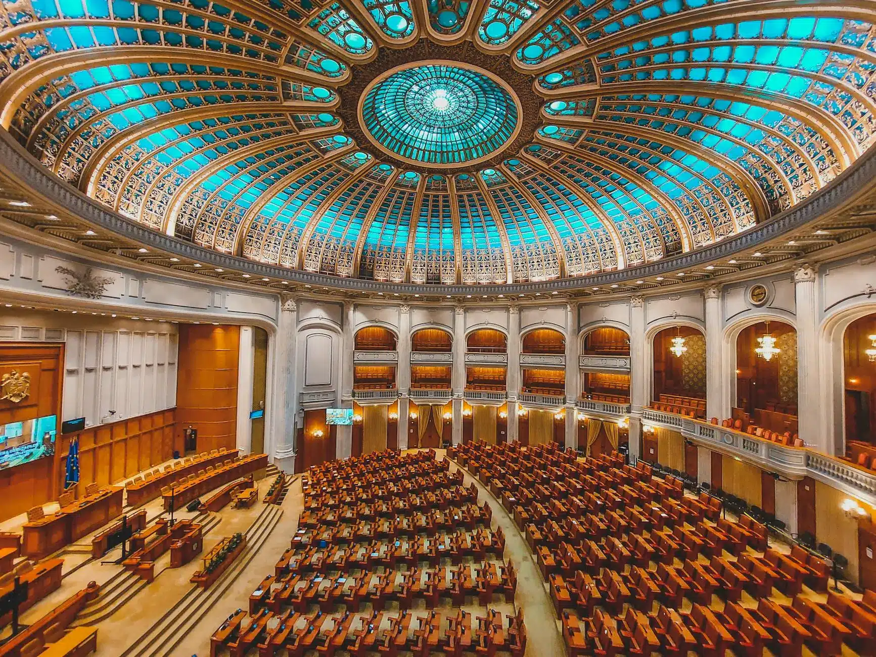 Interior of a grand legislative chamber featuring ornate architecture and seating.