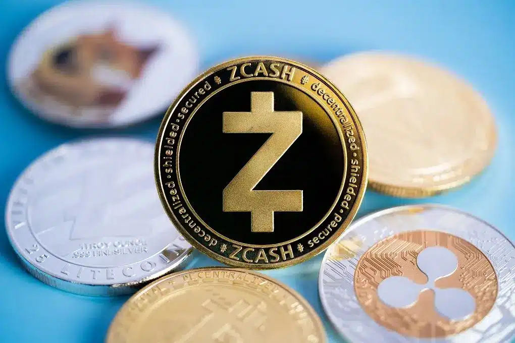 A close-up of a Zcash cryptocurrency coin among other coins.