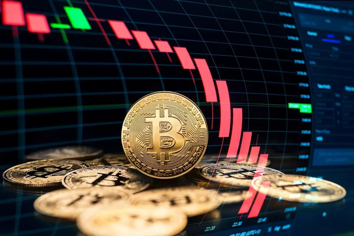 Bitcoin physical coins on a graph displaying price fluctuations.