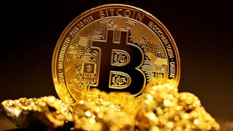 A Bitcoin coin prominently displayed with gold nuggets in the foreground.
