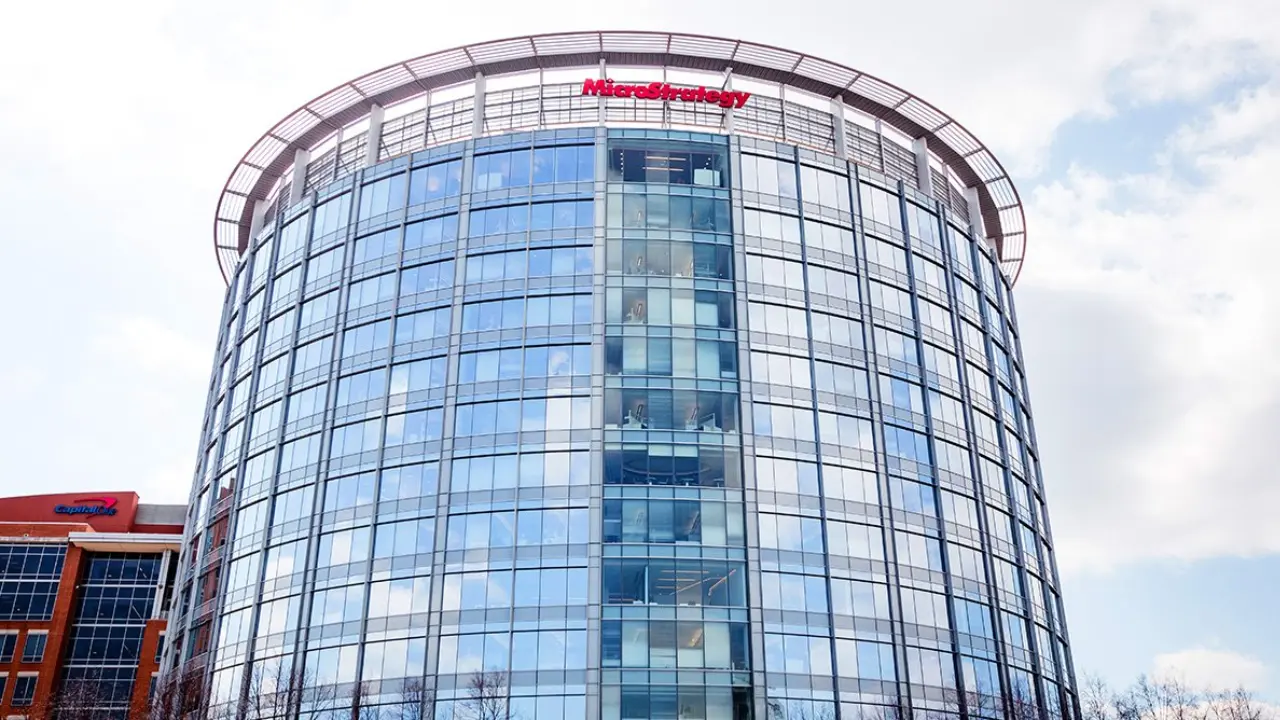 MicroStrategy headquarters office building with glass facade and blue sky.