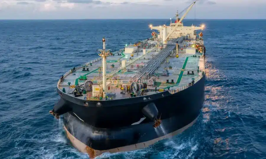 Oil tanker navigating open waters with ocean backdrop.